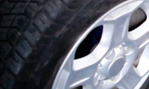 A close-up view of a tire with a silver rim.